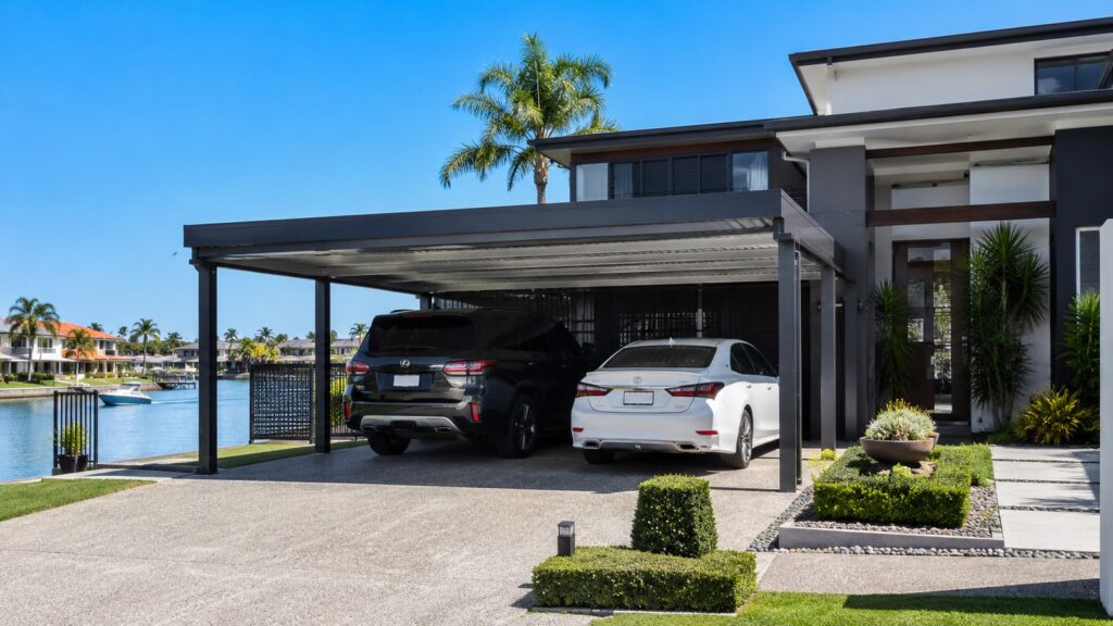 Custom Colorbond double carport at a modern waterfront home in Clear Island Waters.