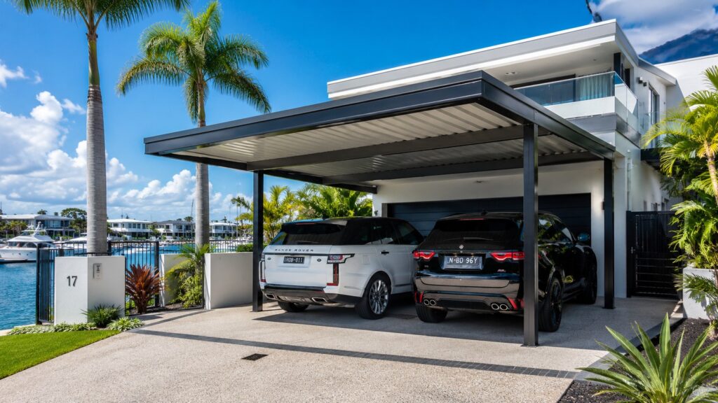 Luxury Hope Island waterfront home with a modern Colorbond steel double carport.