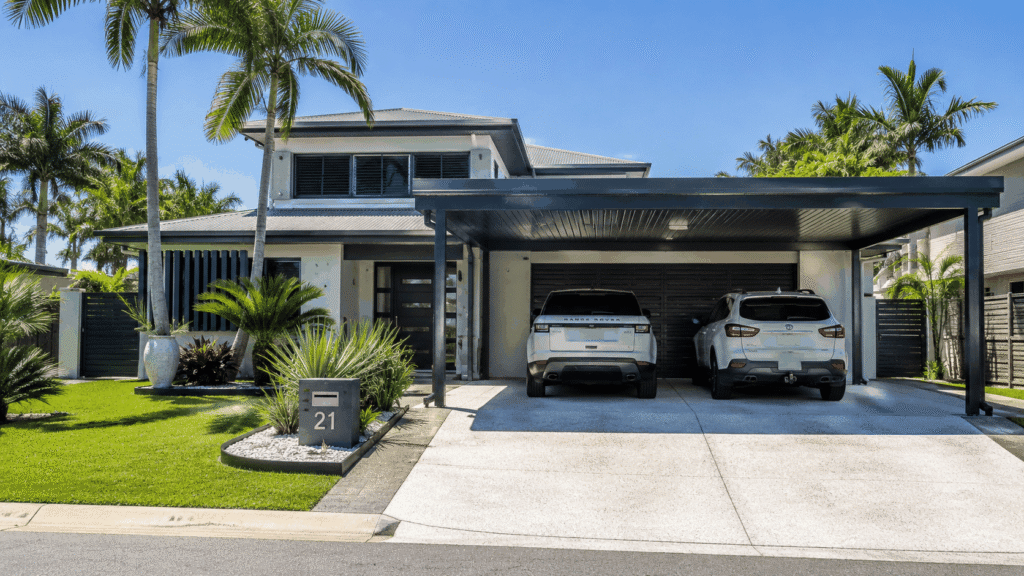 Custom Colorbond double carport protecting two vehicles at a modern Labrador home.