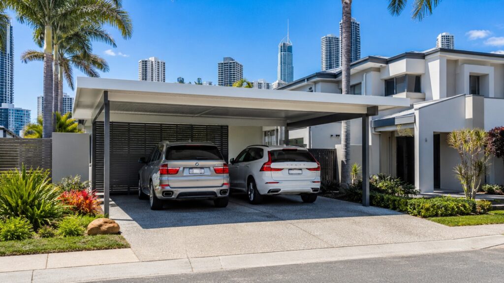 Modern Surfers Paradise home with a Colorbond double carport protecting two SUVs.