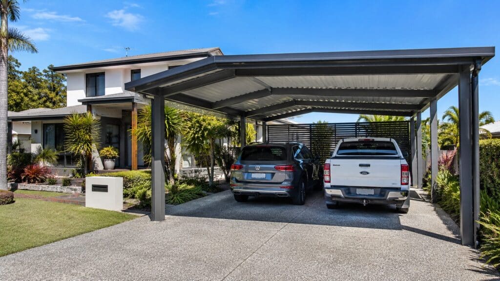 Custom Colorbond steel carport protecting two vehicles at a modern Ashmore home.