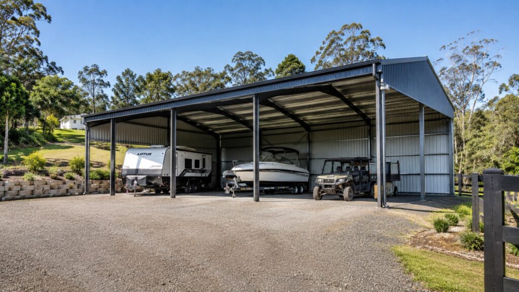 Carport Tallai 3 High-clearance freestanding carport covering a caravan, boat, and rural vehicle on a Tallai property.