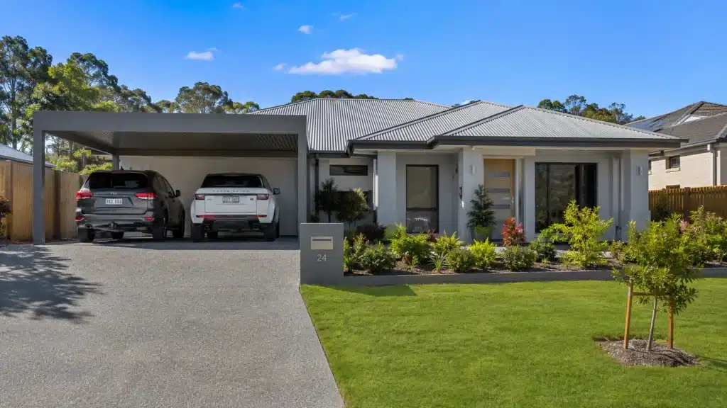 Carport Upper Coomera 2 Custom Colorbond double carport protecting two SUVs at a modern Upper Coomera family home.