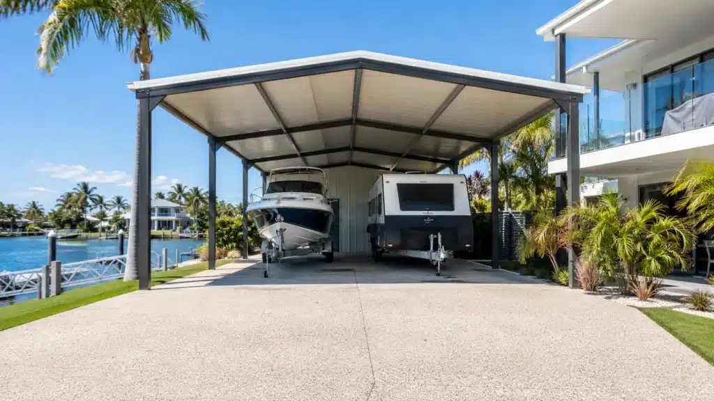 Carport Paradise Point 3 High clearance carport providing covered parking for a boat and caravan.