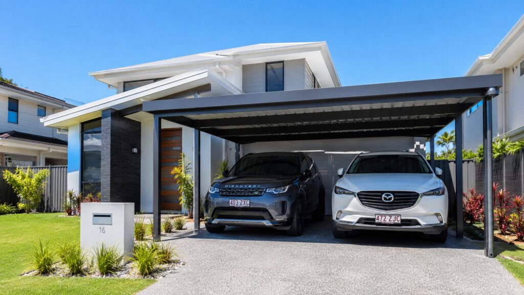 Carport Coomera 2 Modern Coomera home featuring a custom Colorbond steel double carport protecting two family vehicles.