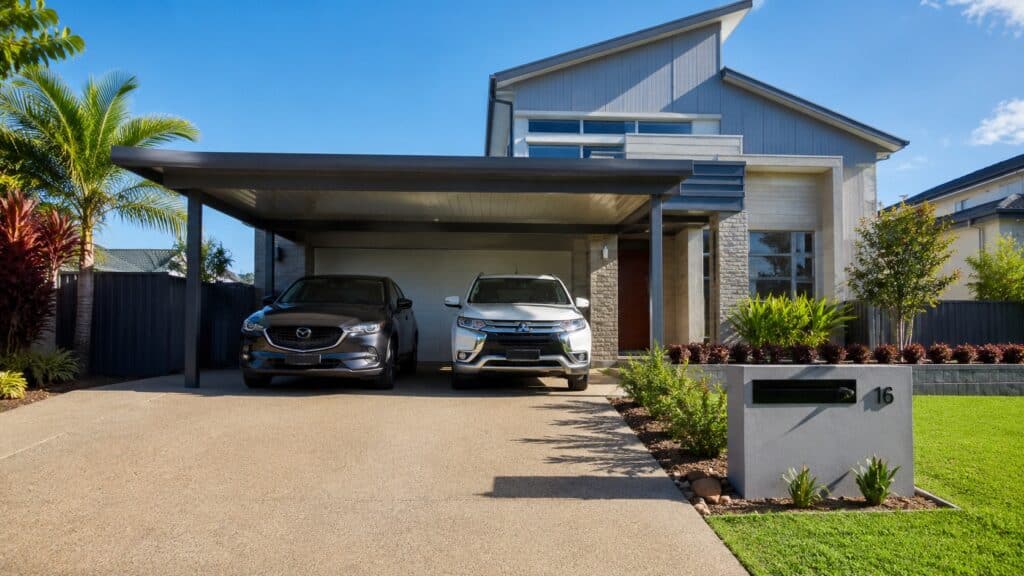 Modern Carrara home with a custom Colorbond steel double carport protecting two vehicles.