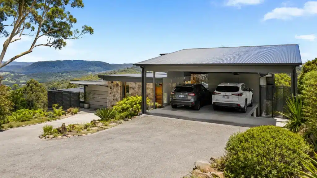 Carport Worongary 2 Custom Colorbond double carport beside a modern home on a sloping Worongary property.